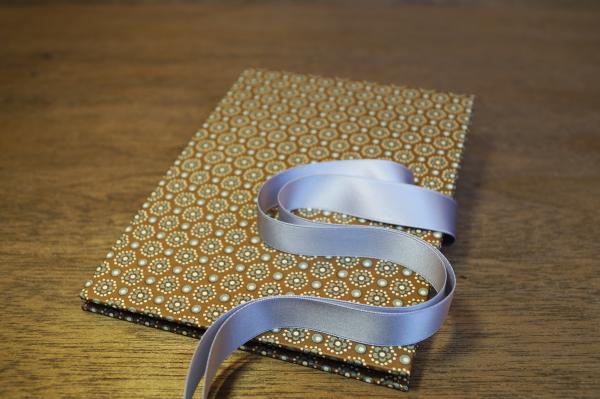 Light brown mini photo book with cream flowers and silver satin bow